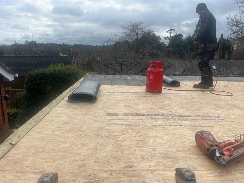 Roofer checking a roof during a free survey