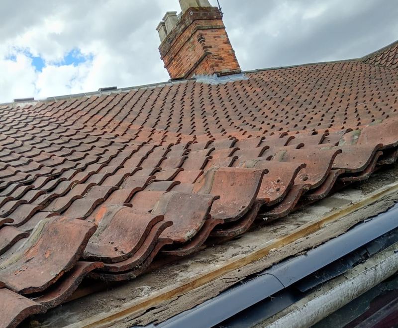Roof tiles and chimney repaired after a leak